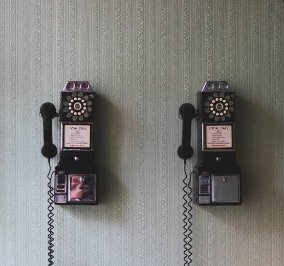 Two old style telephones on the wall