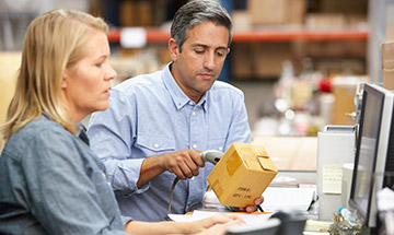  Man and woman working in a warehouse 