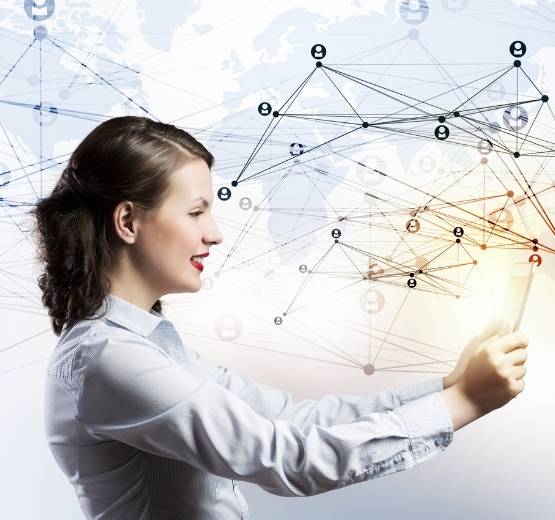 Lady holding a tablet in front of a blurry data map