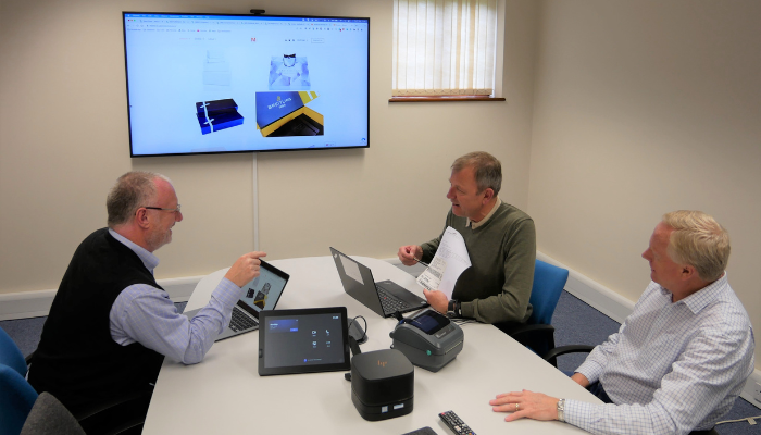 Two BrightBridge consultants and a man from Monro discussing the next phase of an ERP implementation project. 