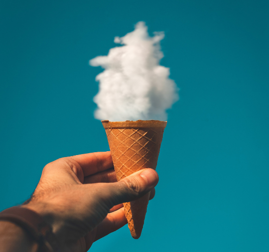 Person holding ice cream cone in front of a cloud so it looks like ice cream to represent innovative customisations in the NetSuite cloud ERP solution.